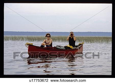 Stock Image - Couple canoeing. Fotosearch