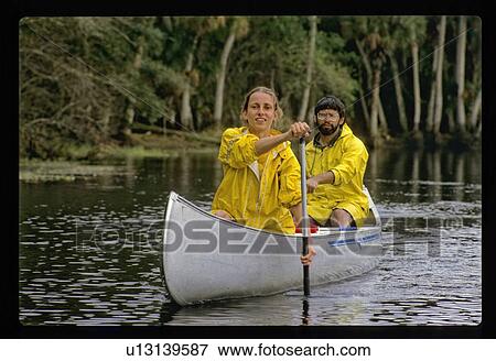 Couple in a canoe View Large Photo Image Stock Photo - Couple in a canoe. Fotosearch