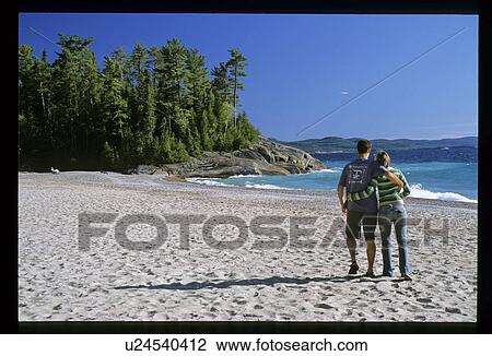 Stock Image - Couple on a beach. Fotosearch