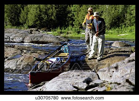 Stock Image - Docking a canoe. Fotosearch