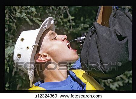 Stock Photo - Drinking during a hike . Fotosearch