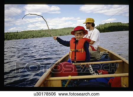 Stock Photograph - Father and son in a canoe. Fotosearch
