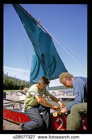 Fixing a canoe with a sail View Large Photo Image Stock Photo - Fixing a canoe with a sail. Fotosearch