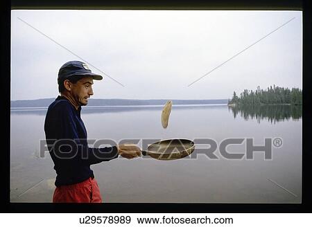 Stock Photo - Flipping pancakes on the shore. Fotosearch