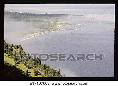 Stock Image - Flying over the coast. Fotosearch