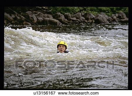 Girl with helmet in the water View Large Photo Image Stock Photo - Girl with helmet in the water. Fotosearch