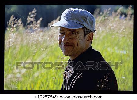 Head shot of man with long grass background View Large Photo Image Stock Photo - Head shot of man with long grass background. Fotosearch
