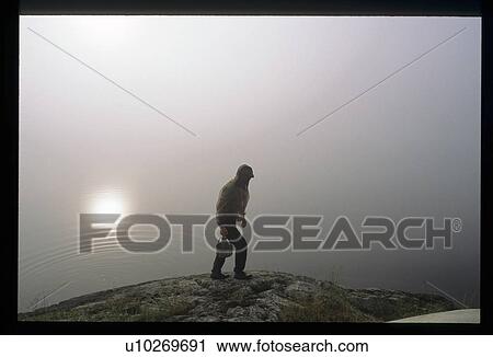 Stock Image - Hiking in the fog. Fotosearch