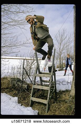 Jumping off a ladder View Large Photo Image Stock Photo - Jumping off a ladder . Fotosearch