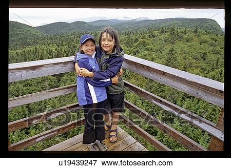 Stock Photo - Kids hugging on a lookout. Fotosearch