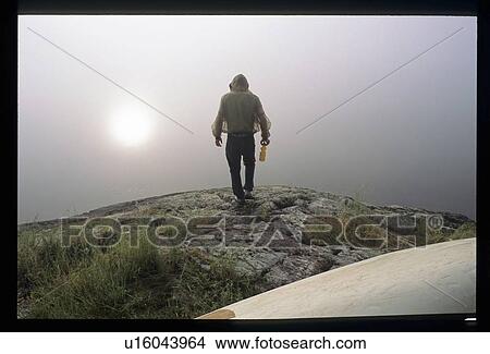 Looking into the fog on a cliff View Large Photo Image Picture - Looking into the fog on a cliff. Fotosearch