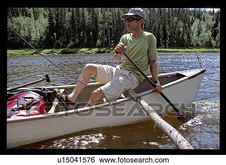 Stock Photograph - Man canoeing. Fotosearch