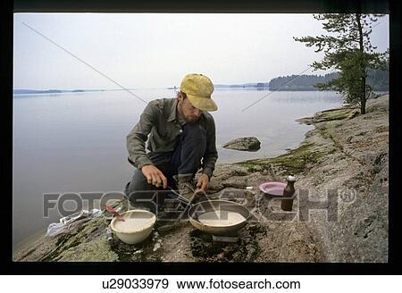 Man cooking outdoors View Large Photo Image Stock Photo - Man cooking outdoors. Fotosearch