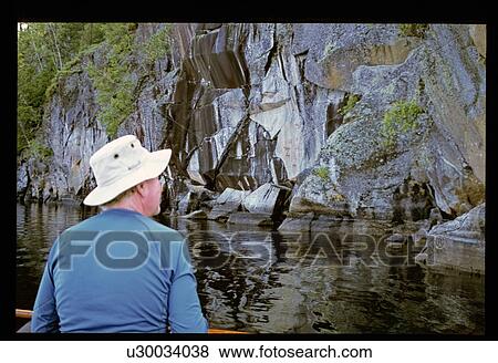 Stock Photo - Man in boat on river. Fotosearch