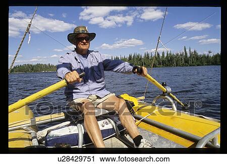Man paddling boat View Large Photo Image Stock Image - Man paddling boat. Fotosearch