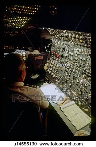 Stock Image - Manning the control room. Fotosearch