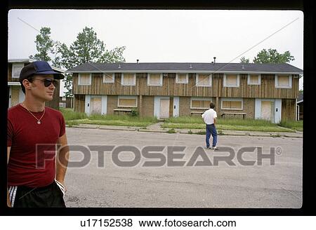 Stock Photo - Men by a vacant apartment building. Fotosearch