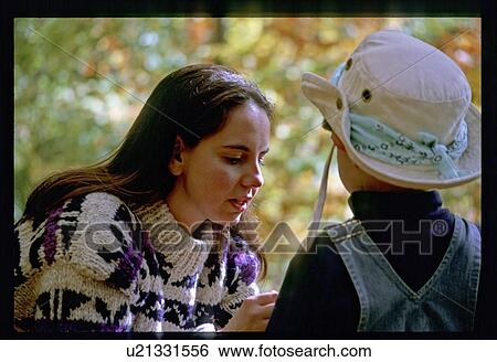 Stock Photograph - Mother helping a son. Fotosearch