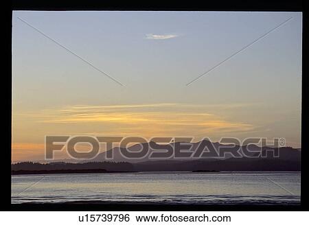 Stock Photograph - Mountain sunset over a lake. Fotosearch
