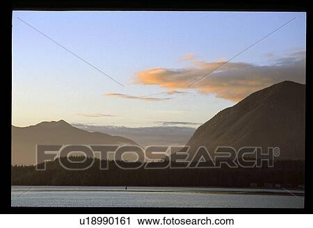 Stock Image - Mountains around a lake. Fotosearch