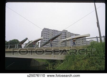 Stock Image - People carrying canoes . Fotosearch