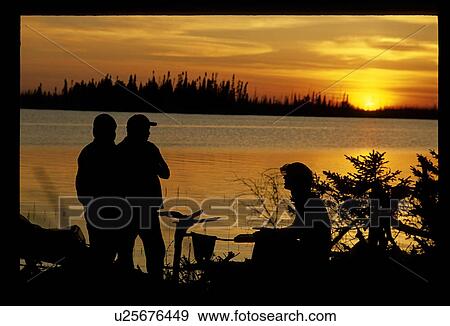 People on a shoreline View Large Photo Image Stock Photo - People on a shoreline . Fotosearch