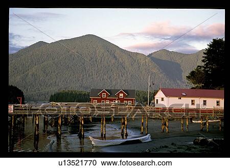 Stock Image - Piers with houses by mountains. Fotosearch