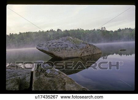 Stock Photo - Rock in a lake. Fotosearch