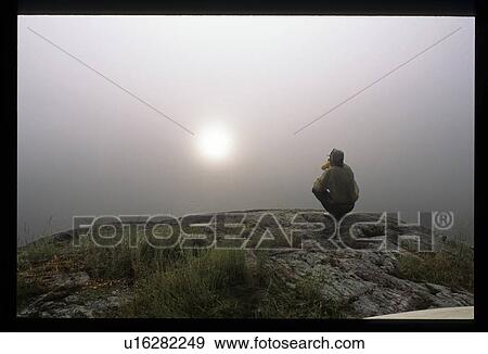 Stock Photo - Sitting on a cliff. Fotosearch