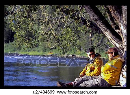 Stock Photo - Sitting on the shoreline . Fotosearch