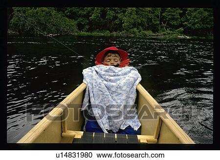 Stock Image - Sleeping in a canoe. Fotosearch