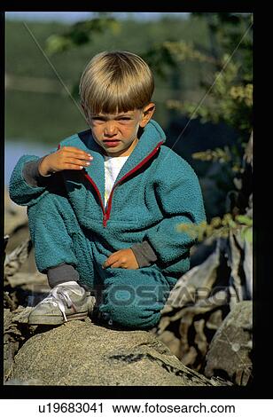Small boy sitting on rocks View Large Photo Image Stock Image - Small boy sitting on rocks. Fotosearch