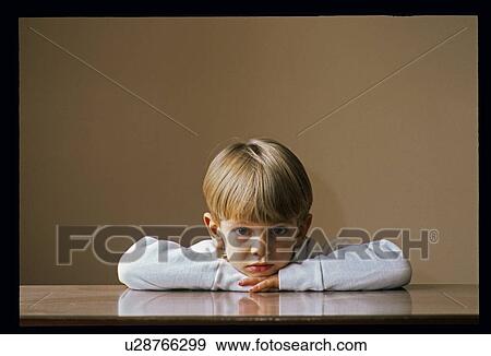 Stock Photo - Small boy with chin on hands. Fotosearch