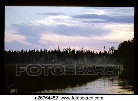 Stock Image - Sunset over a lake. Fotosearch