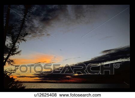 Stock Photo - Sunset over a lake. Fotosearch