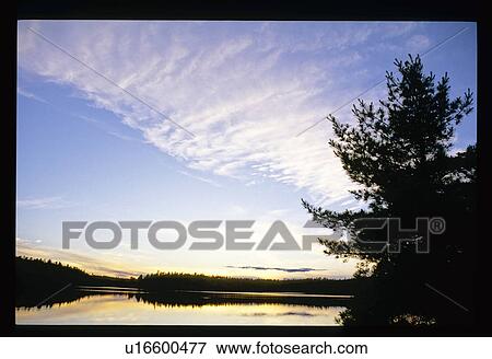 Stock Photo - Sunset over a lake . Fotosearch
