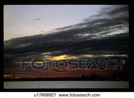 Stock Photo - Sunset over a lake. Fotosearch