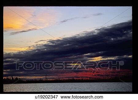 Stock Photo - Sunset over a lake. Fotosearch
