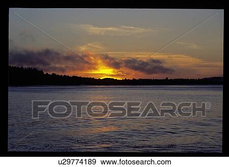 Sunset over a lake View Large Photo Image Stock Photo - Sunset over a lake. Fotosearch