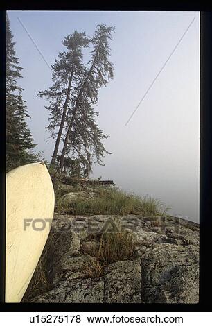 Stock Photo - Surfboard by a cliff. Fotosearch