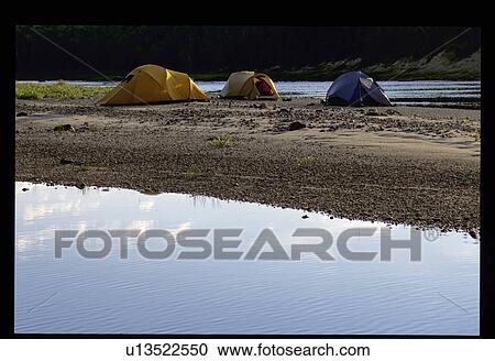 Stock Image - Tents by the water. Fotosearch