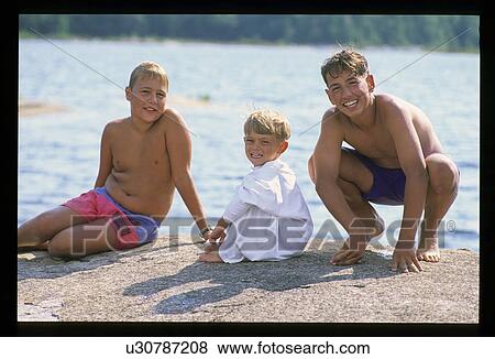 Three boys at the lake View Large Photo Image Stock Photo - Three boys at the lake. Fotosearch