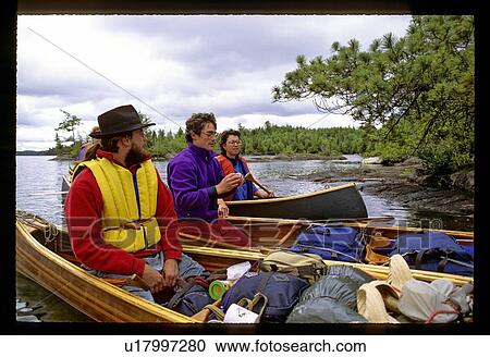 Three canoes with people in them View Large Photo Image Stock Image - Three canoes with people in them. Fotosearch