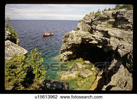 Stock Image - Towboat by a rock wall. Fotosearch