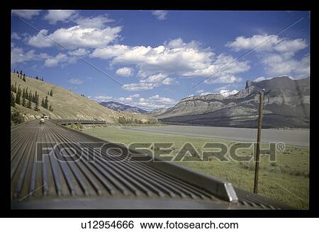 Stock Photograph - Train though mountains . Fotosearch
