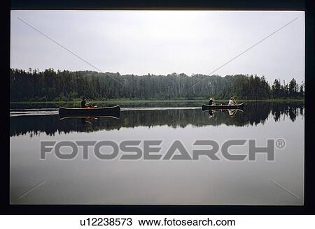Two canoes in a lake View Large Photo Image Stock Image - Two canoes in a lake. Fotosearch
