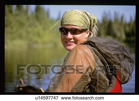 Stock Photo - Woman canoeing . Fotosearch