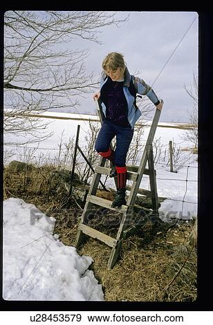 Woman jumping off a ladder View Large Photo Image Stock Photo - Woman jumping off a ladder. Fotosearch