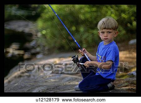 Stock Photo - Young boy with fishing pole. Fotosearch
