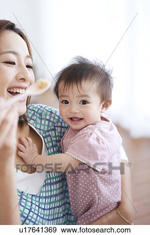 Stock Photo - Baby Being Fed. Fotosearch